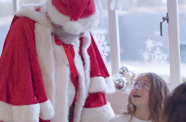 Little girl looking up at Santa