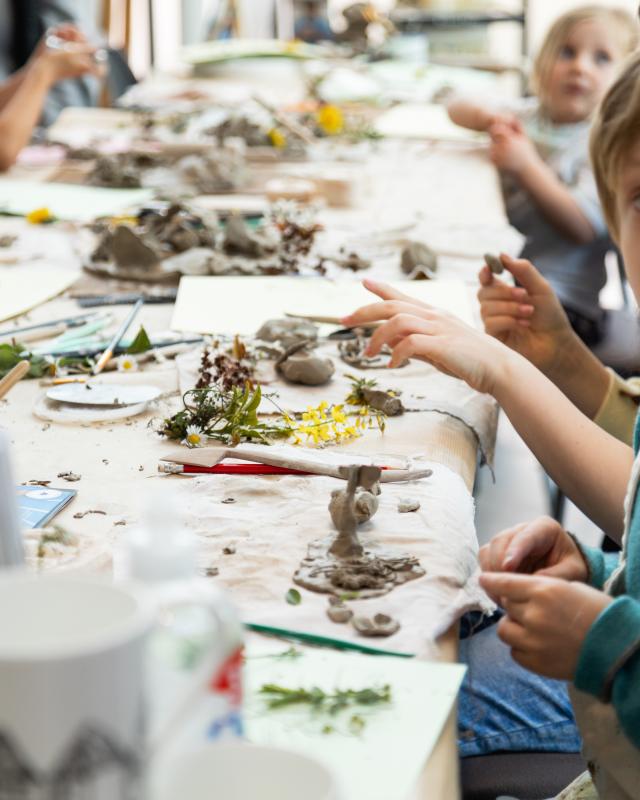 Children playing with clay and plants