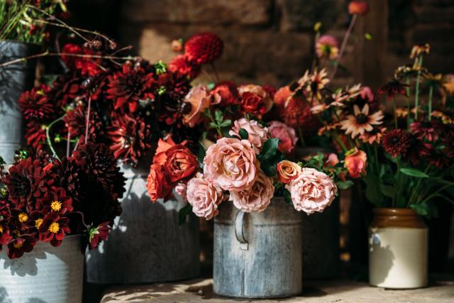 Floral display, red and light pink flowers in an assortment of buckets