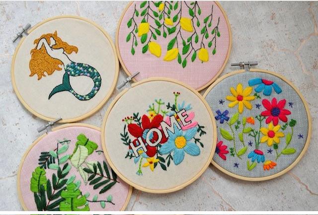 image of embroidery examples, five circle frames with varying patterns
