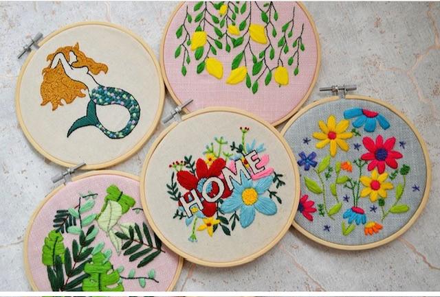 image of embroidery examples, five circle frames with varying patterns