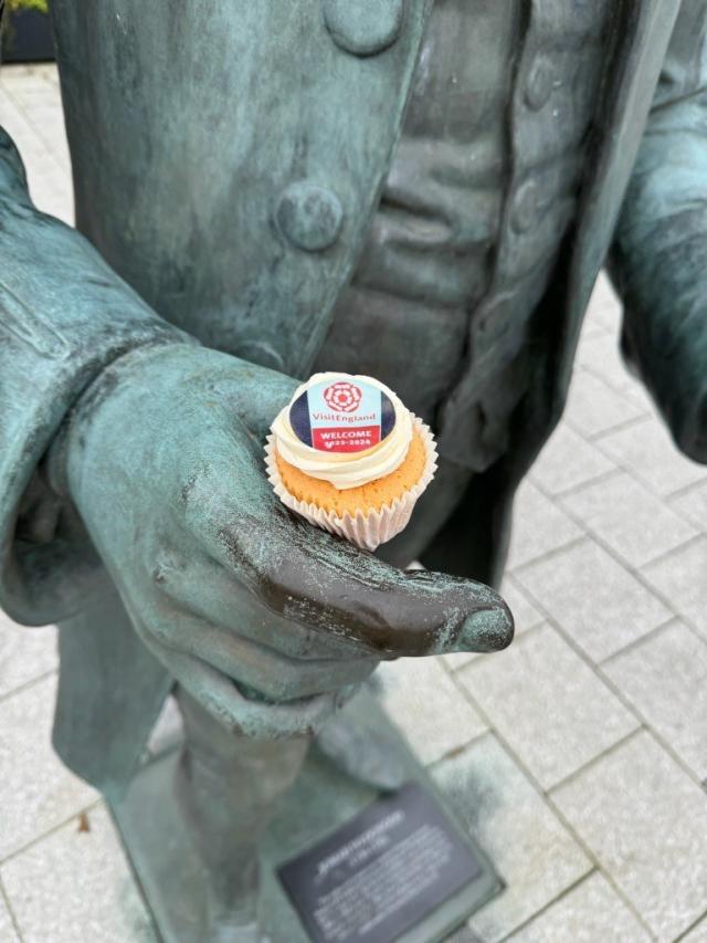 Josiah statue holding cupcake