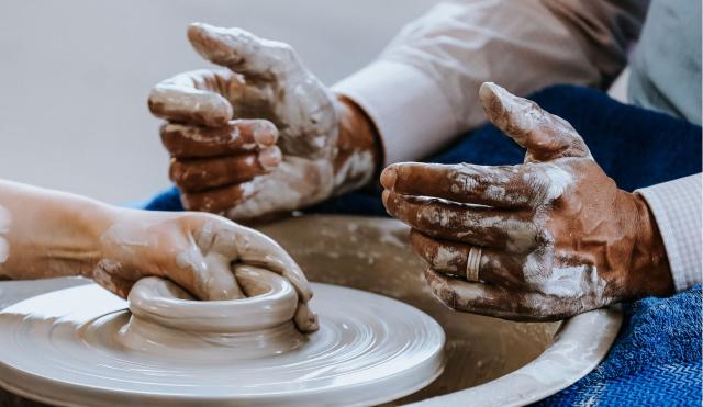 Hands on potters wheel