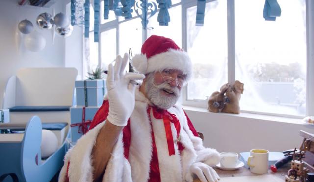 Santa infornt of sleigh at desk