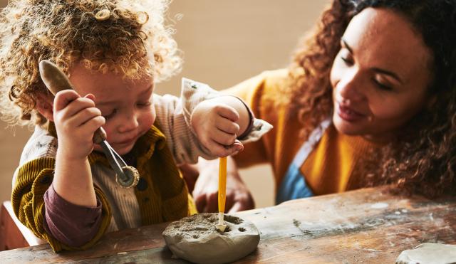 Woman and child playing with clay