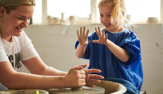 Child and adult on Potter's Wheel.