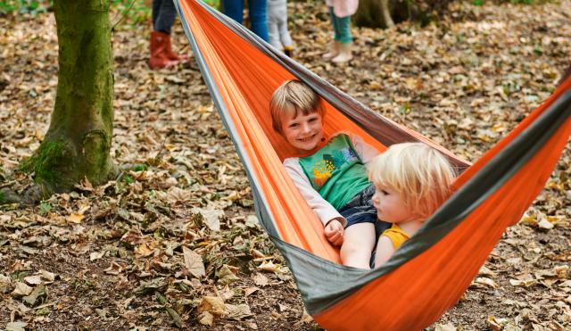 Kids in hammock in woods