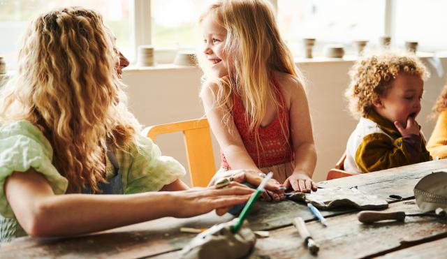 mother and daughter playing with clay