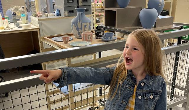 Child in factory pointing 
