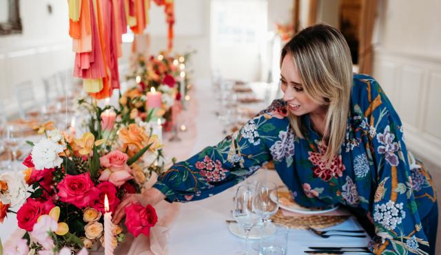 Victoria at a table display, arranging a flower 