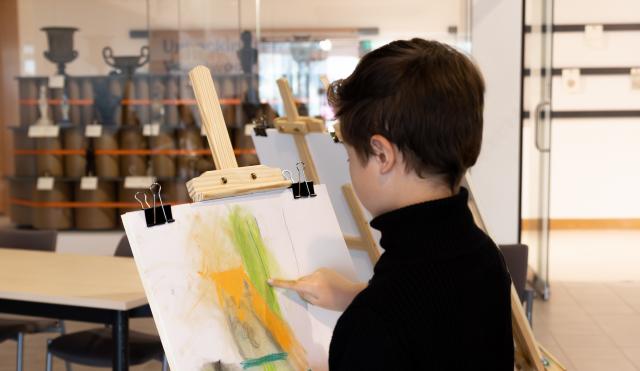 Boy with easel and drawing