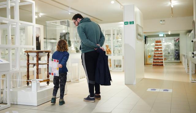 Man and child looking at items in the V&A Wedgwood Collection
