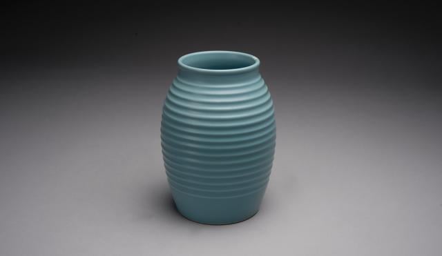image of a keith murray vase, which is blue in colour and ribbed affect on a plain background
