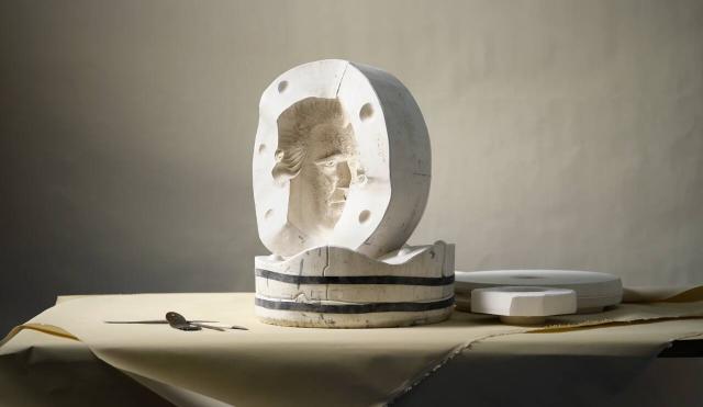 Josiah head in a mould on plain cream background