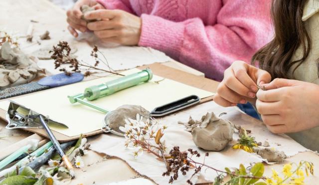 People using their hands making clay